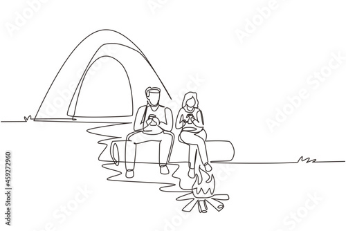 Single continuous line drawing couple hikers sitting on log of wood near campfire in forest. Man woman drinking hot tea, coffee, camping gear and backpack. One line draw design vector illustration