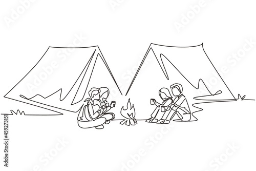 Single one line drawing two couple camping around campfire tents. Group of people sitting on ground, drinking hot tea, man playing guitar, getting warm near bonfire. Continuous line draw design vector