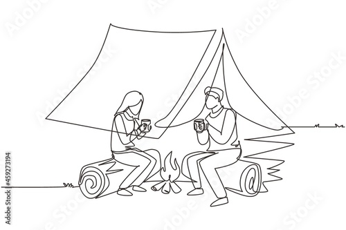 Single one line drawing couple near bonfire, romantic date out of town, camping. Man and woman getting warm near campfire and drinking tea sitting on logs in forest. Continuous line draw design vector