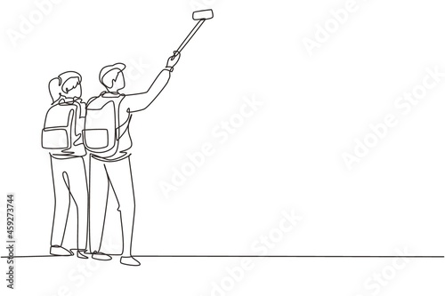 Continuous one line drawing couple man woman hikers with backpacks takes selfie in mountains while recording video using his smartphone. Travel blogger. Single line draw design vector illustration