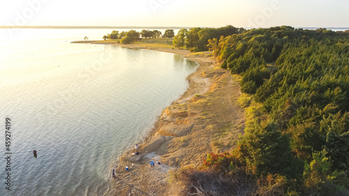 Top view people bank fishing along the sandy shore line at Ticky Creek Park, Lake Lavon, Texas, USA photo