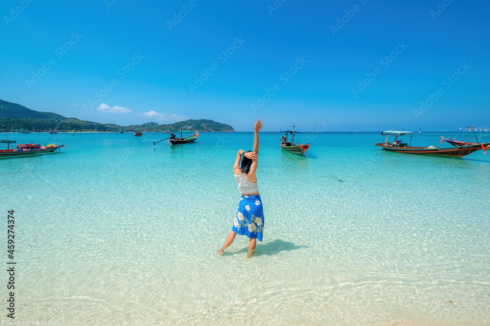 woman on the beach, clear water sea with blue sky on the Holiday, palm tree beach, at Haad Chaloklum beach, koh phangan island,suratthani , thailand