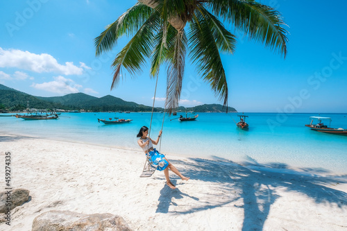 Fototapeta Naklejka Na Ścianę i Meble -  woman on the beach, clear water sea with blue sky on the Holiday, palm tree beach, at Haad Chaloklum beach, koh phangan island,suratthani , thailand