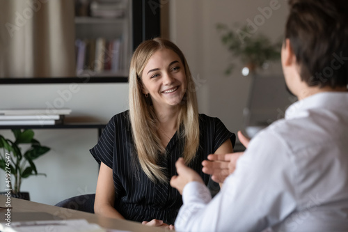 Canvas Print Happy intern listening to mentor, consulting advisor, talking to supervisor, smiling, laughing