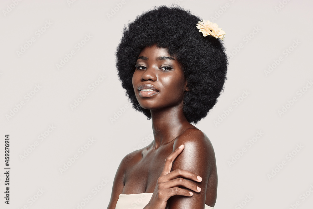 Portrait of beautiful young African woman looking at camera and smiling Portrait of beautiful young African woman looking at camera and smiling