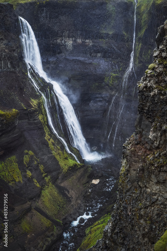 Haifoss waterfall in South Iceland in the dusk. Beautiful nature dramatic moody landscape. Vertical view