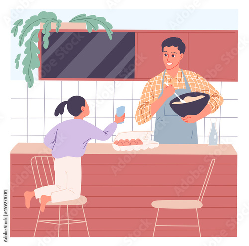 Father cooks a meal and his little daughter wants to join him