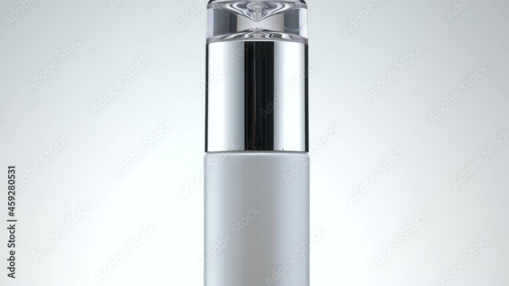 Blank bottle on white background slowly rotates in air for product design and advertising. The blank cosmetic for mockup. Blank bottle on white background slowly rotates in air for product design and advertising. The blank cosmetic for mockup.