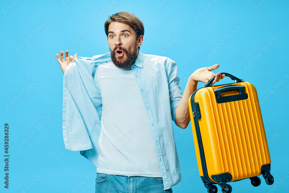man with yellow suitcase on blue background travel surprise model man with yellow suitcase on blue background travel surprise model