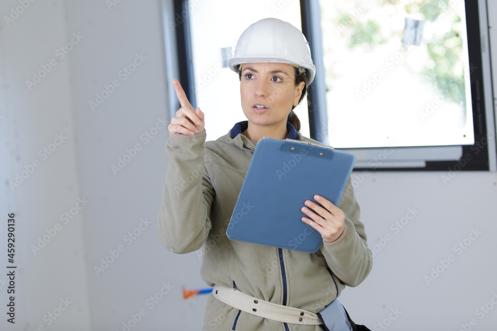 woman builder holding a clipboard woman builder holding a clipboard