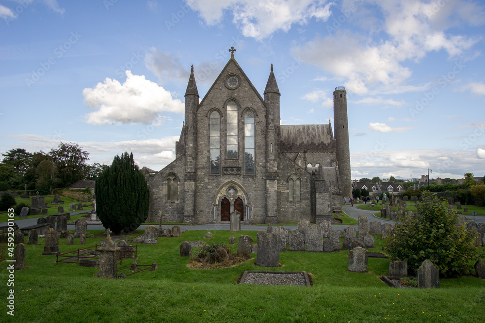old church with tombstones and blue sky in ireland, Cathedral Church of. St Canice