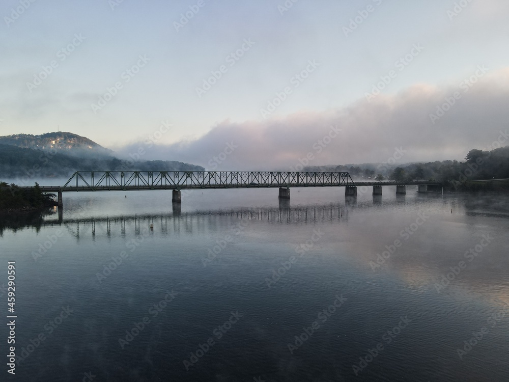 A bridge over water with a foggy sunrise. Bridge is on Lake Allatoona in Cartersville