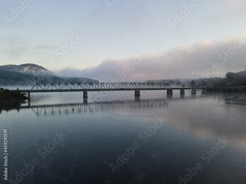 A bridge over water with a foggy sunrise. Bridge is on Lake Allatoona in Cartersville © Jeremy