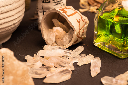 Witchcraft table set, selective focus at magic crystal stones for alchemy and esoteric cult. Spiritual occultism and magic chemistry inspired by mysticism. Witch, warlock magician concept. Halloween. photo