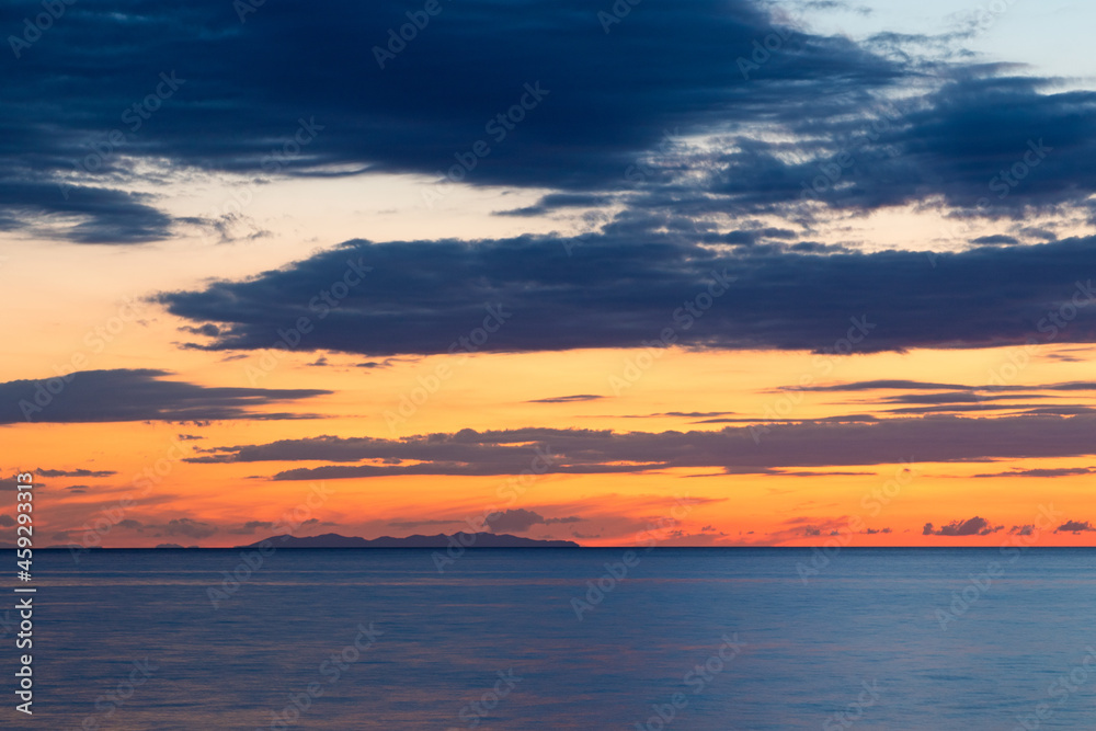 Sunset on Mediterranean sea behind Capraia Island, Tuscany Italy