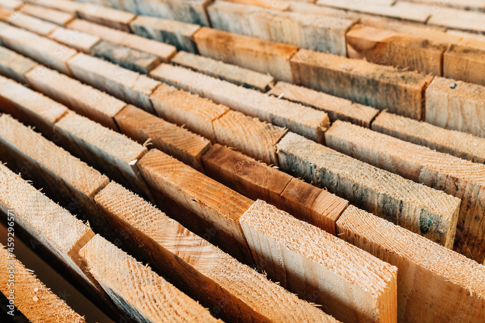 Stacked rustic wooden boards as construction material Stacked rustic wooden boards as construction material