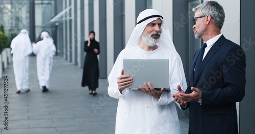 Photography Waist up of multi-ethnic professional managers working near the modern office