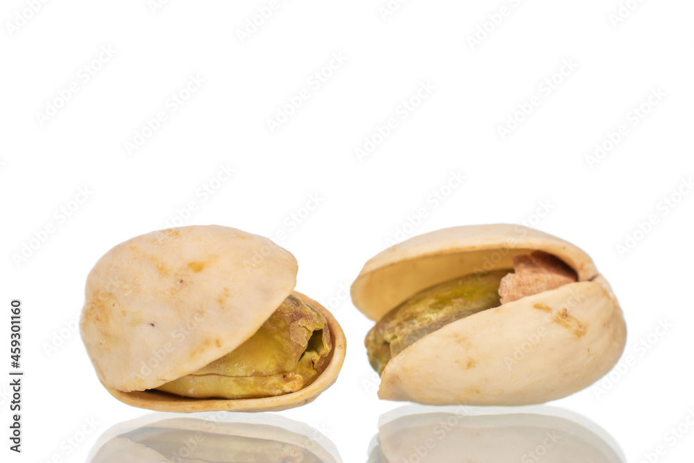 Two unpeeled pistachios, close-up, isolated on white. Two unpeeled pistachios, close-up, isolated on white.