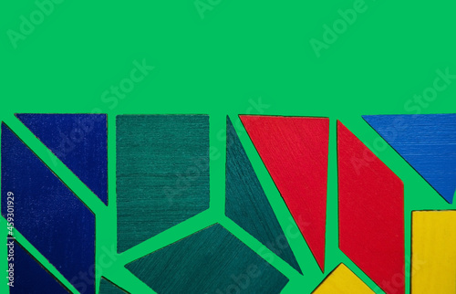 Abstract background.Geometric shapes in different colors on a green background. The concept of logical thinking.