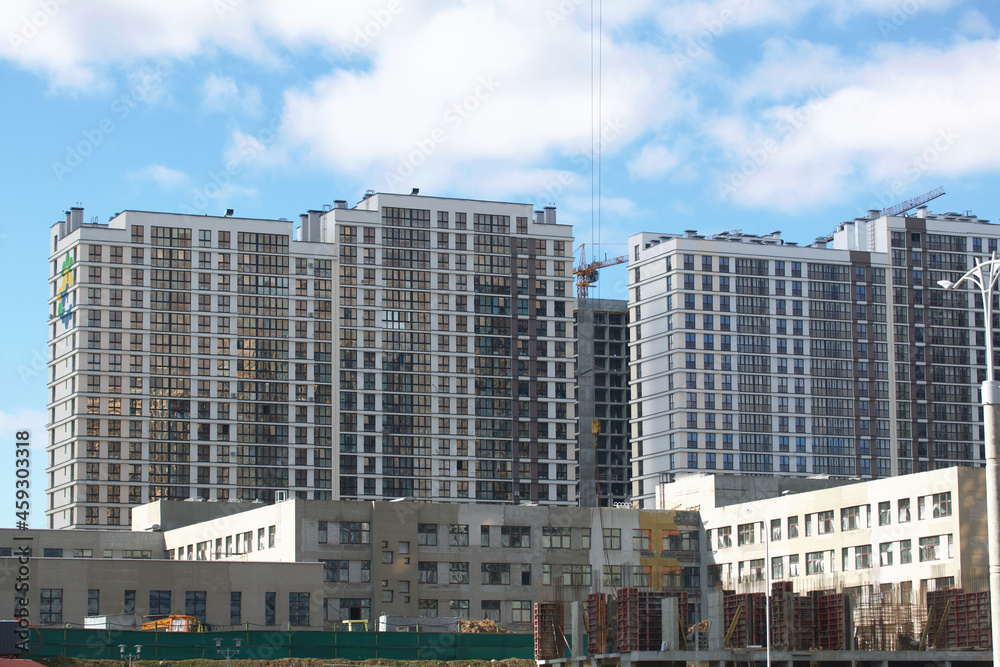Construction of modern multi-storey buildings. Construction of a new city block. Buildings under construction are visible.