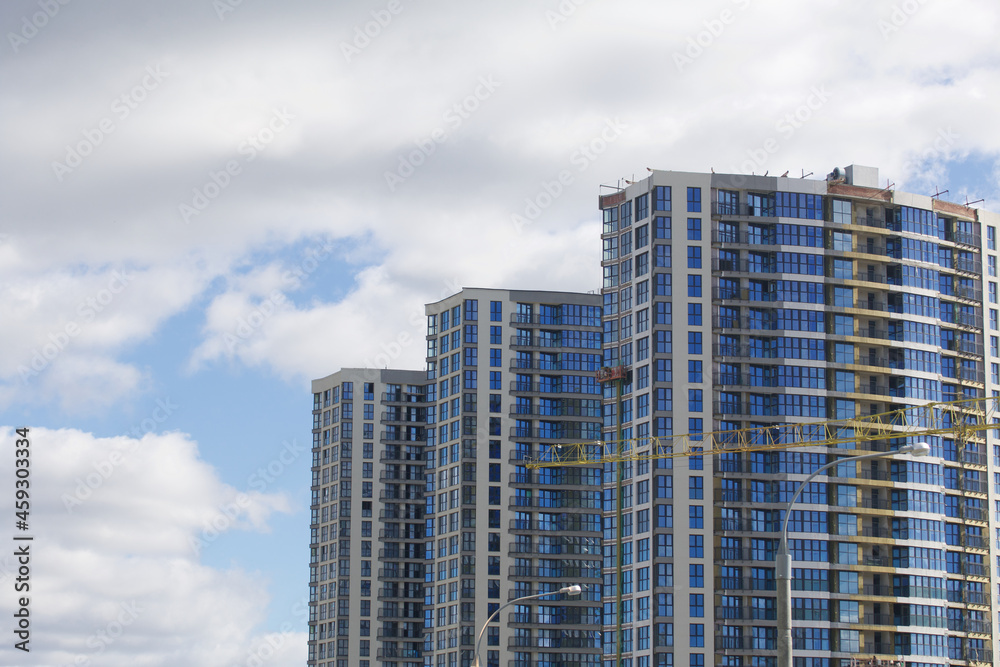 Construction of modern multi-storey buildings. Construction of a new city block. Buildings under construction and tower cranes.