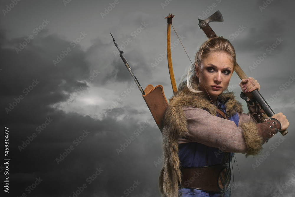 Beautiful female viking woman warrior in battle with ax and bow with  arrows. Amazon fantasy blonde hair sexy girl foto de Stock | Adobe Stock