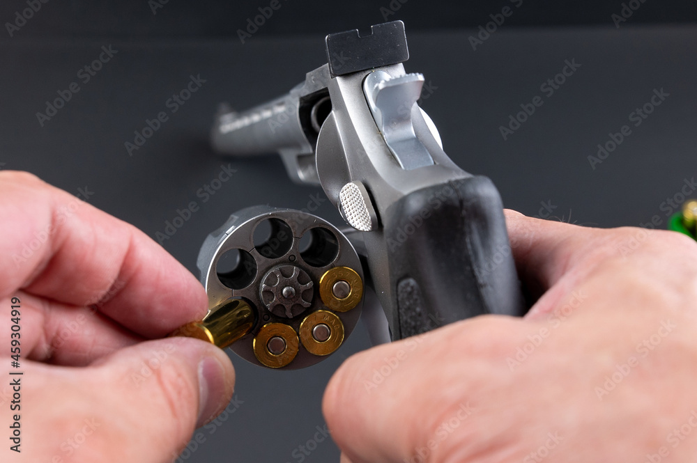 Loading .357 magnum rounds into a revolver Stock Photo | Adobe Stock