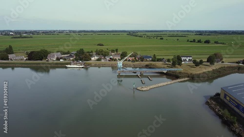 Blue old abandoned industrial crane at river Hollandse IJssel in the Netherlands, aerial photo