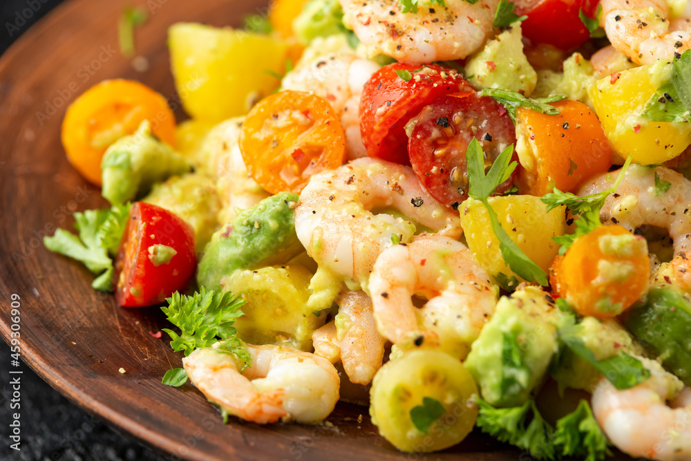 Prawn avocado salad with tomato cherry and herbs. Healthy food