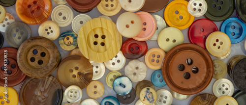 Many colorful garment buttons in various shapes and sizes, Flat layout, top view