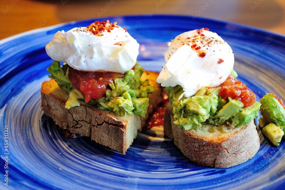 Avocado toast with poached eggs and salsa sauce, served in Newcastle, UK Avocado toast with poached eggs and salsa sauce, served in Newcastle, UK