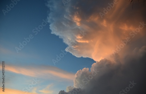 Giant cumulonimbus cloud with sunlight and blue sky background