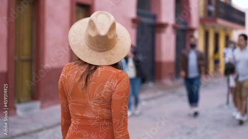 unrecognizable woman walking on the street