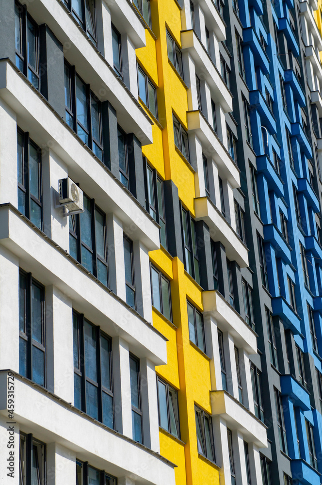 Wall of a modern new building with windows. Beautiful juicy colored building texture for background Wall of a modern new building with windows. Beautiful juicy colored building texture for background