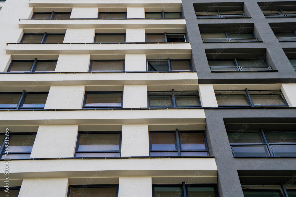 Wall of a modern new building with windows. Beautiful juicy colored building texture for background Wall of a modern new building with windows. Beautiful juicy colored building texture for background