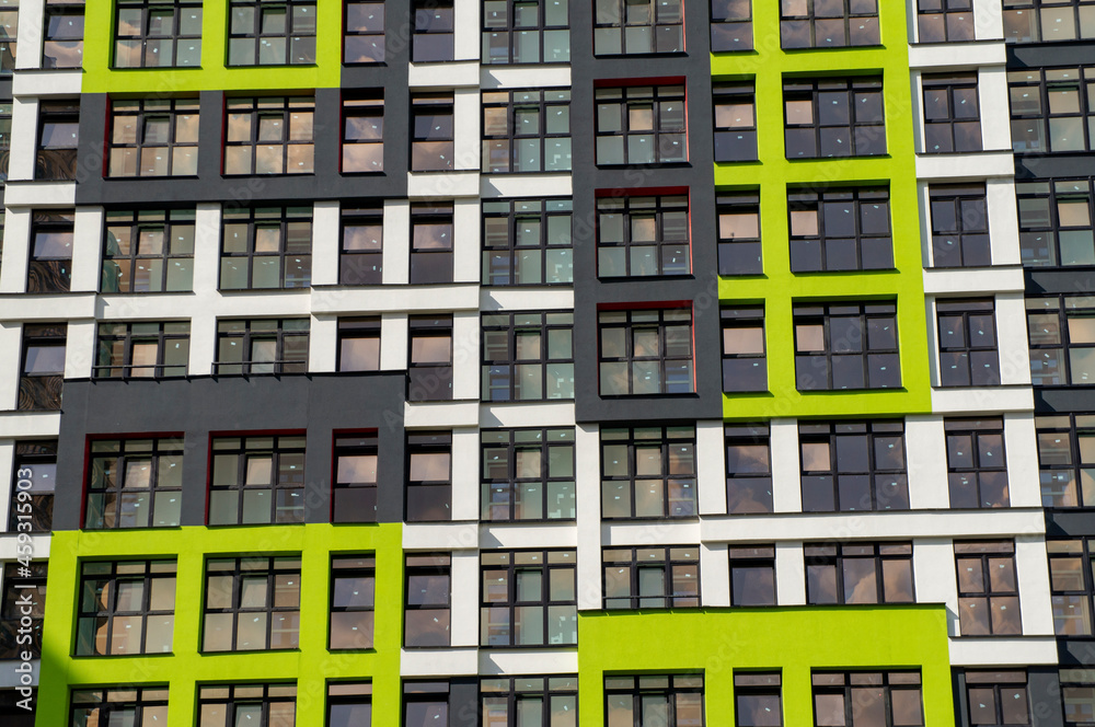 Wall of a modern new building with windows. Beautiful juicy colored building texture for background