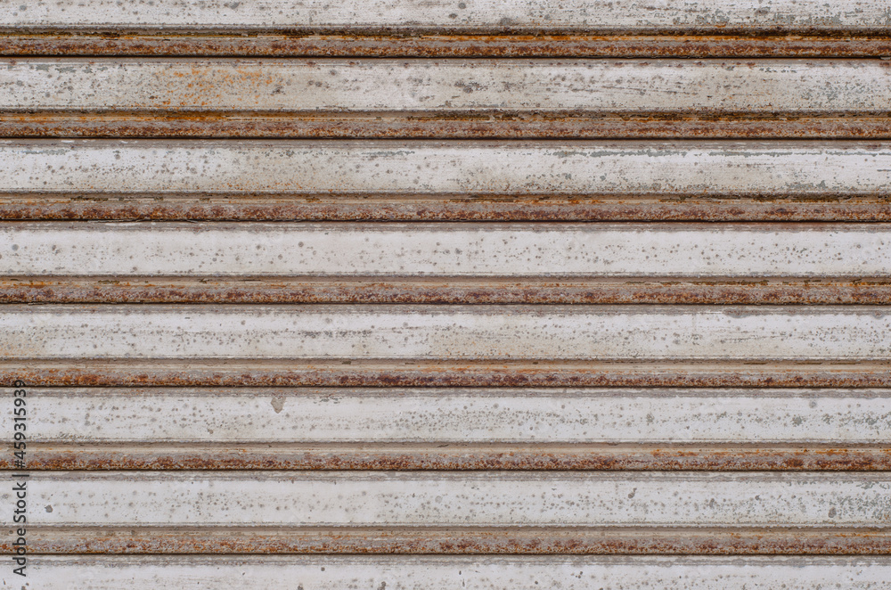 close-up of rusty corrugated iron shutter. concept of time passing, security and closed. design wallpapers