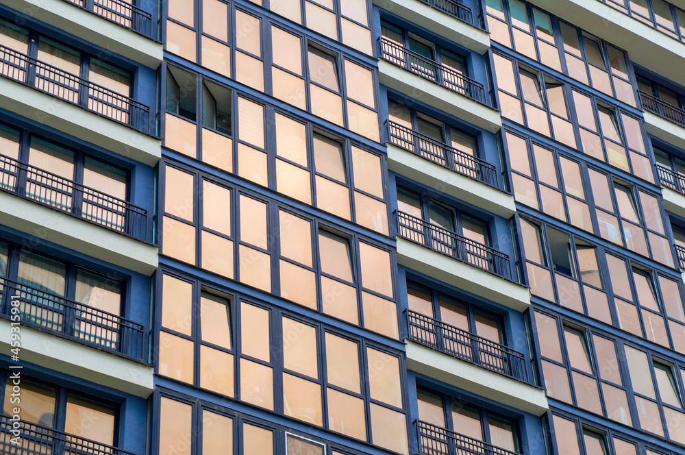 Wall of a modern new building with windows. Beautiful stylish building texture for background Wall of a modern new building with windows. Beautiful stylish building texture for background