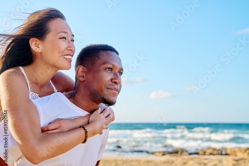 Young beautiful having fun couple on the sea background