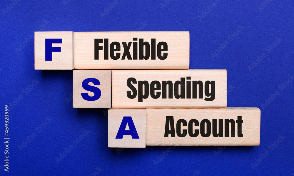 On a bright blue background, light wooden blocks and cubes with the text FSA Flexible Spending Account
