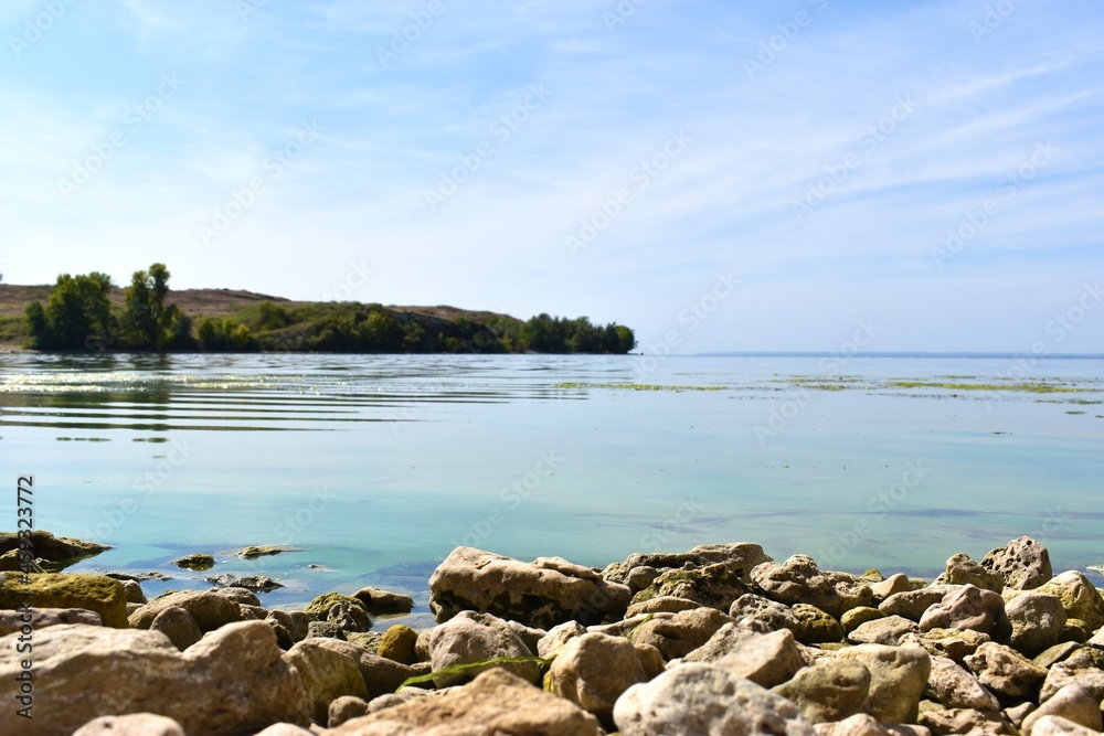Stone coast and river against the blue sky Stone coast and river against the blue sky