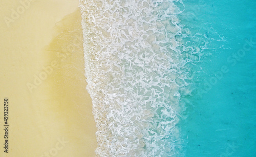 Top view of the beautiful ocean shore with waves and foam on the sand. Seychelles. Texture and background tourism design