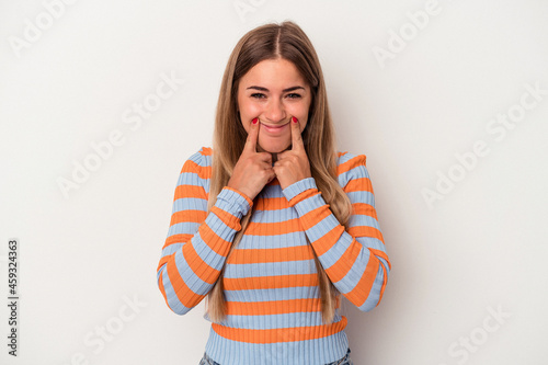 Young Russian woman isolated on white background doubting between two options. © Asier
