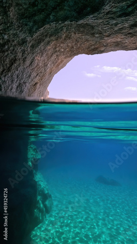 Underwater split photo of beautiful paradise volcanic white rock famous Kleftiko with emerald crystal clear sea and caves, Milos island, Cyclades, Greece