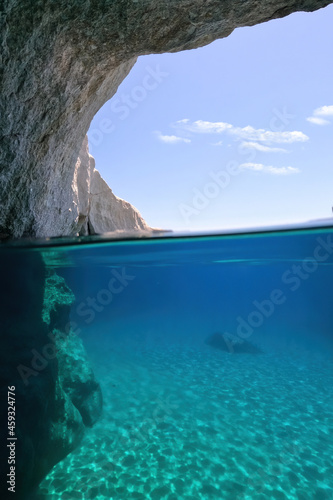 Underwater split photo of beautiful paradise volcanic white rock famous Kleftiko with emerald crystal clear sea and caves, Milos island, Cyclades, Greece © aerial-drone