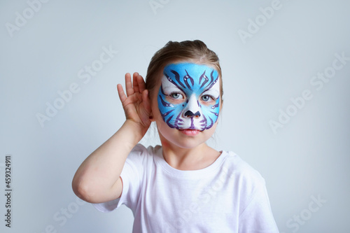 Girl aqua makeup in the form of a blue water tiger zodiac on a white background, concept symbol of the new year 2022, overhears a portrait. High quality photo © Svetlana Repnitskaya