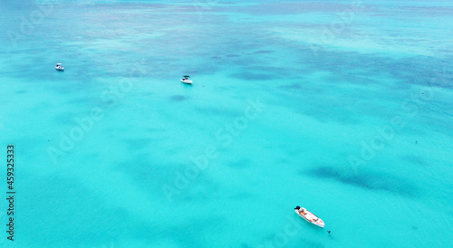 Top view of the gorgeous emerald clear ocean water in the Seychelles. Boats on the water
