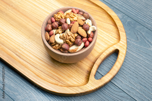 assorted nuts on a kitchen wooden board. vitamin vegetarian food