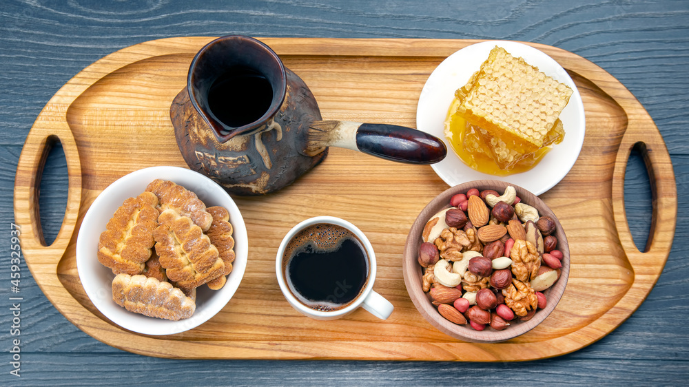 fresh hot coffee with turkey and dried citrus, nuts and honeycomb on a kitchen wooden board. useful vitamin food for the human body fresh hot coffee with turkey and dried citrus, nuts and honeycomb on a kitchen wooden board. useful vitamin food for the human body