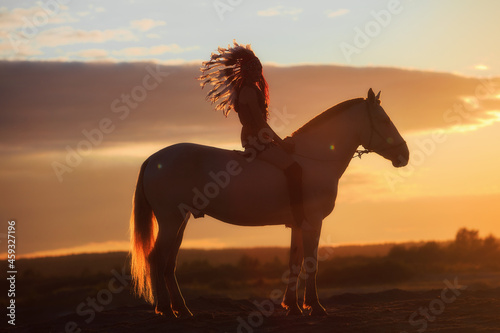 An Indian and a horse at sunset
